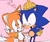 Size: 1170x993 | Tagged: safe, artist:sontaiis, miles "tails" prower, sonic the hedgehog, 2025, abstract background, alternate version, arm around shoulders, blushing, christmas, cute, duo, eyes closed, gay, hat, heart, shipping, smile, sonabetes, sonic x tails, standing, tailabetes, yellow gloves