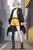 Size: 512x768 | Tagged: safe, ai art, oc, oc:somber the hedgehog, human, asymmetrical legwear, boots, grey hair, humanized, jacket, male, oc only, shirt, shorts, single leg pantyhose, yellow eyes
