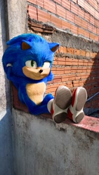 Size: 1153x2048 | Tagged: safe, artist:nathanzicaofici, sonic the hedgehog, 2025, 3d, brick wall, looking at viewer, movie style, outdoors, sitting, smile, solo, wall