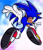 Size: 2048x2359 | Tagged: safe, artist:hedgehogenglne, sonic the hedgehog, 2024, clouds, looking at viewer, looking back, looking back at viewer, mid-air, posing, reaching towards the viewer, signature, sky background, smile, smiling at viewer, solo, style emulation, tan skin, treads, uekawa style, v sign, watermark